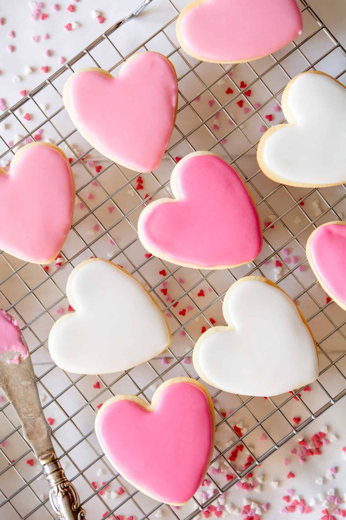 Looking for Valentine’s Day cookie recipe ideas? These Heart-Shaped Sugar Cookies with white and pink pastel royal icing are so simple and delicious. Kids would love to get in on the baking action too and hand out to their school classmates (or crush?). Click pin for this easy step-by-step recipe.