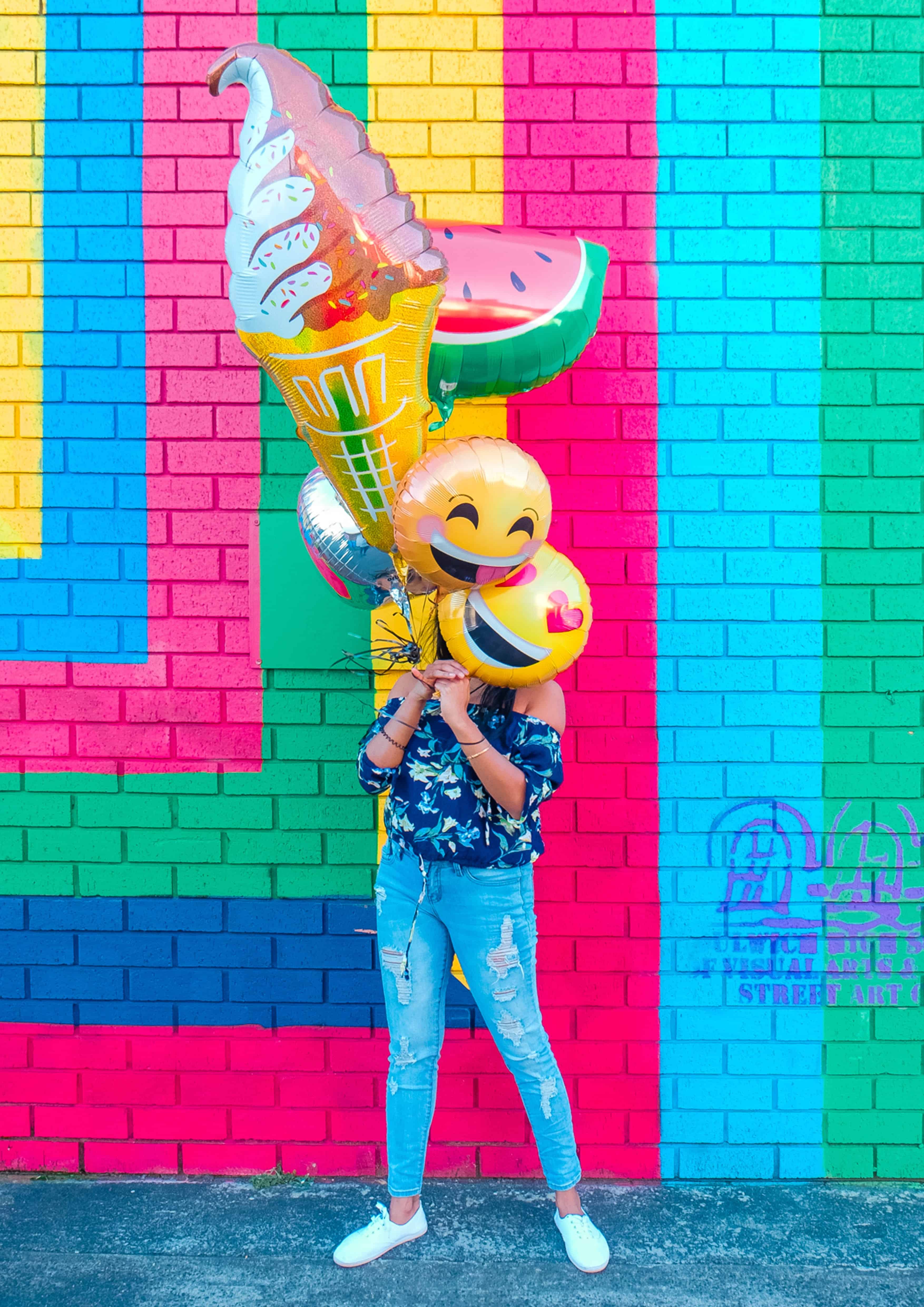person carrying happy balloons