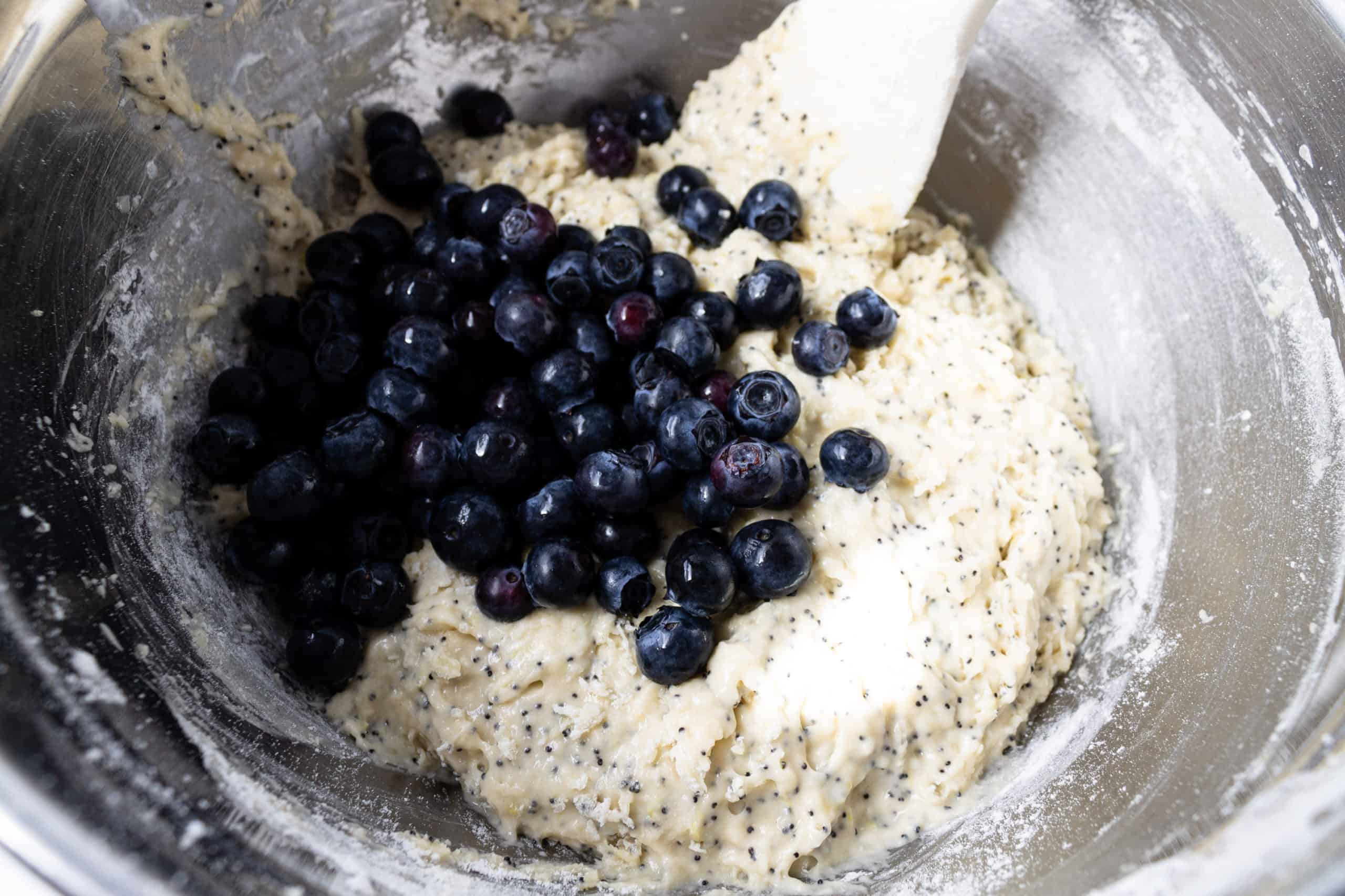 adding blueberries to muffin mixture